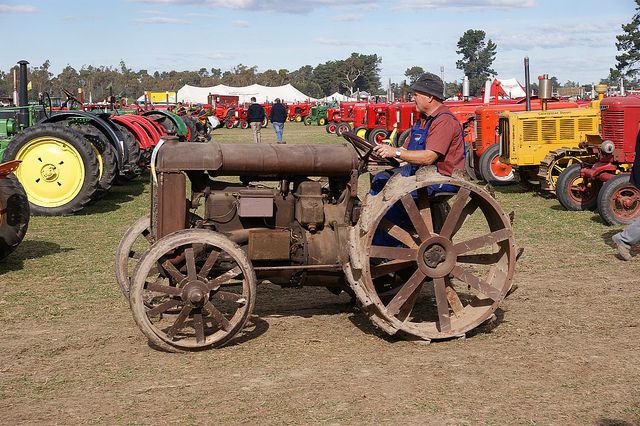 Who are the business people who were tractor manufacturers before entering the automobile industry?